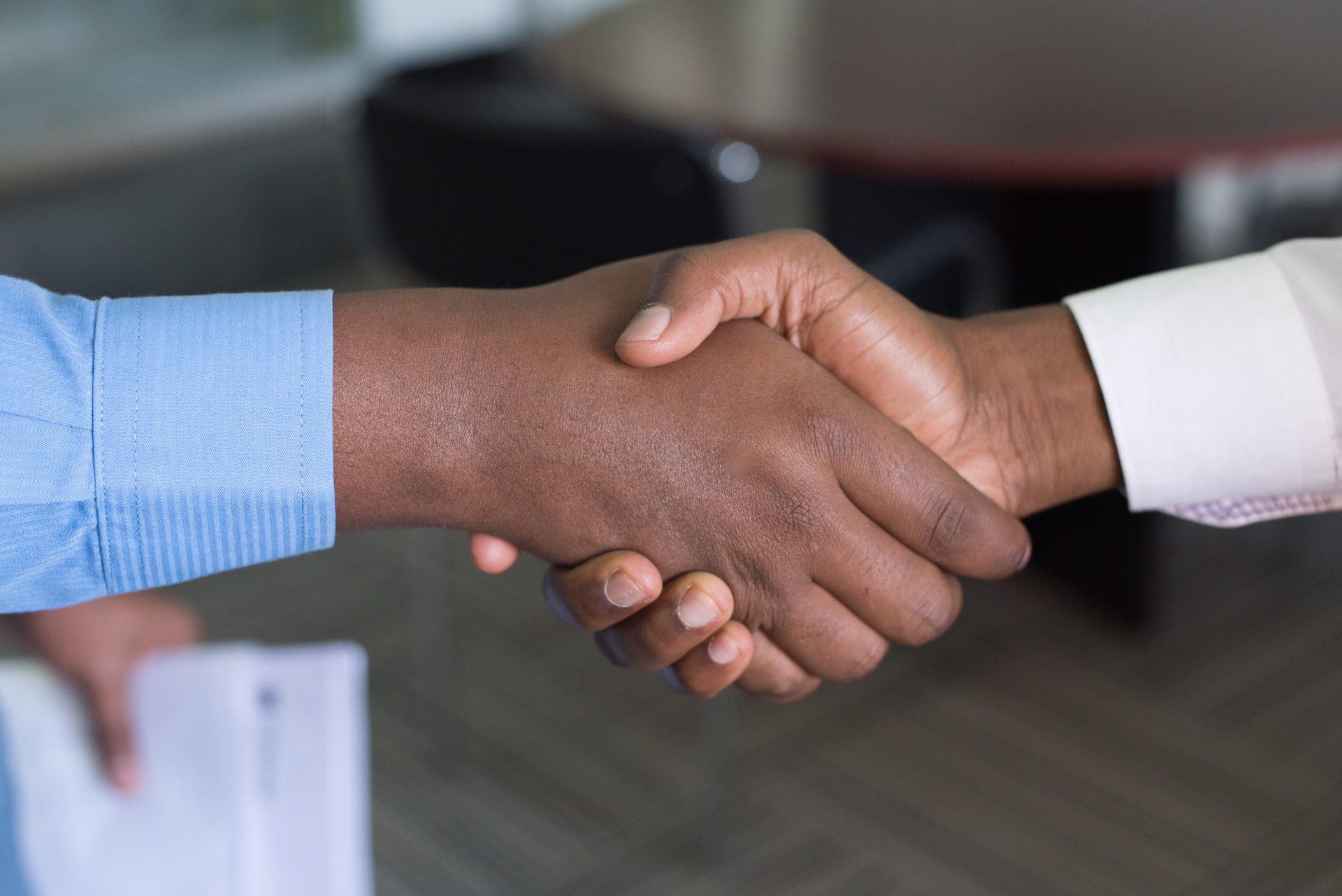 Image of hands shaking to illustrate someone taking a job offer.