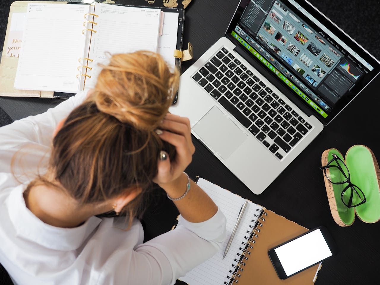 Image shows woman with hands on her head, looking frustrated. Purpose is to encourage job seekers to stick with their jobs instead of job hopping, as this will make their resumes more attractive to potential employers.