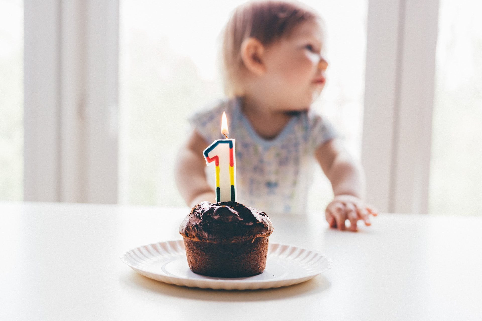 Image shows baby with cupcake and candle shaped in the number 1 to show the idea of creating your first resume.