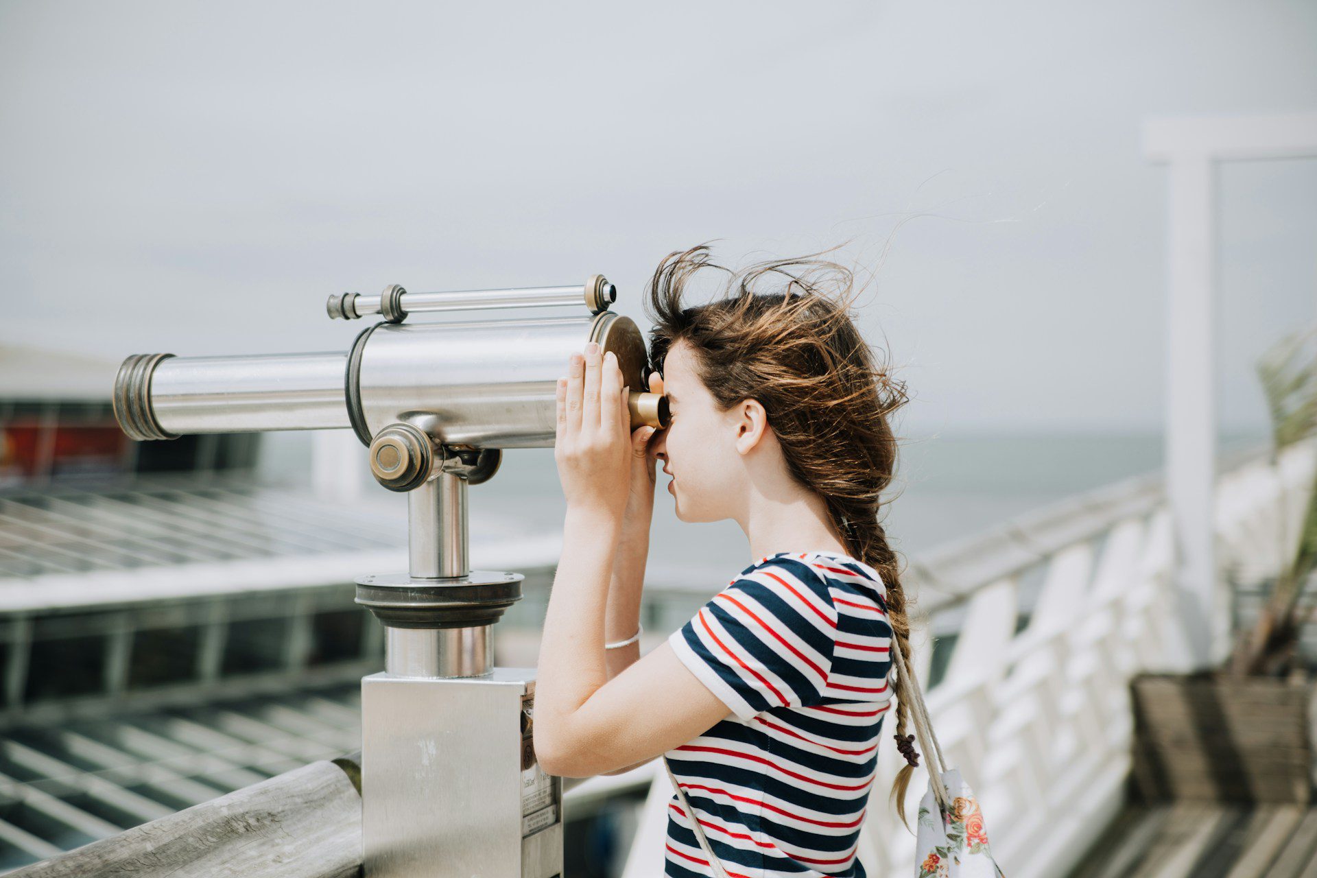 Image shows girl looking through telescope to illustrate topic of the article: Finding book editors near me.