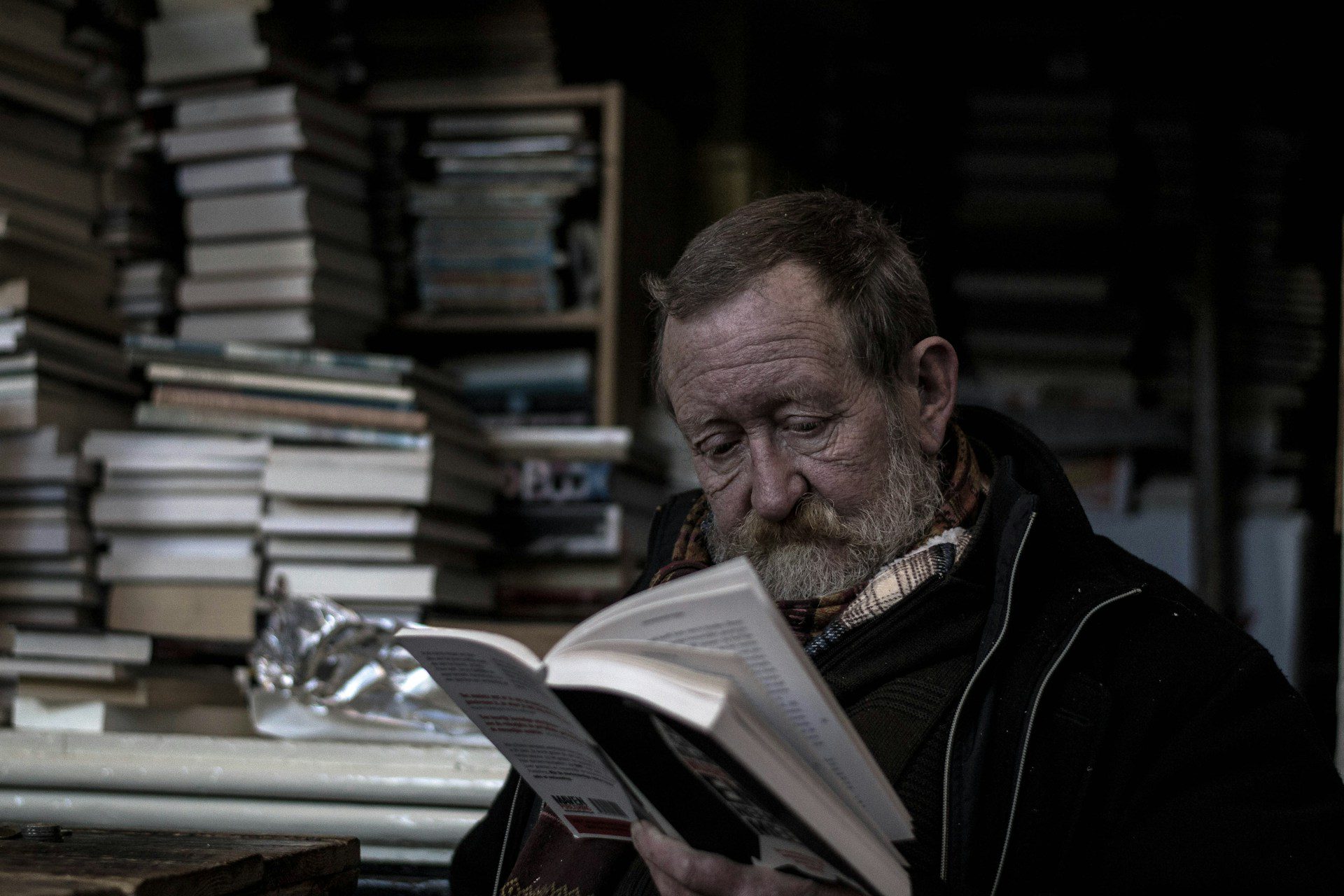 Image shows a man reading a book to illustrate the topic: Why reading matters to a writer.