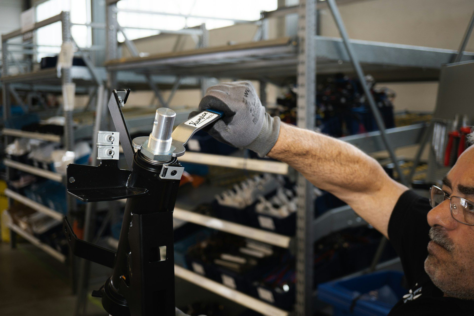 Image shows a man tightening a very large bolt to illustrate the purpose of this blog entry: How to tighten your children's book manuscript for a better reader experience.