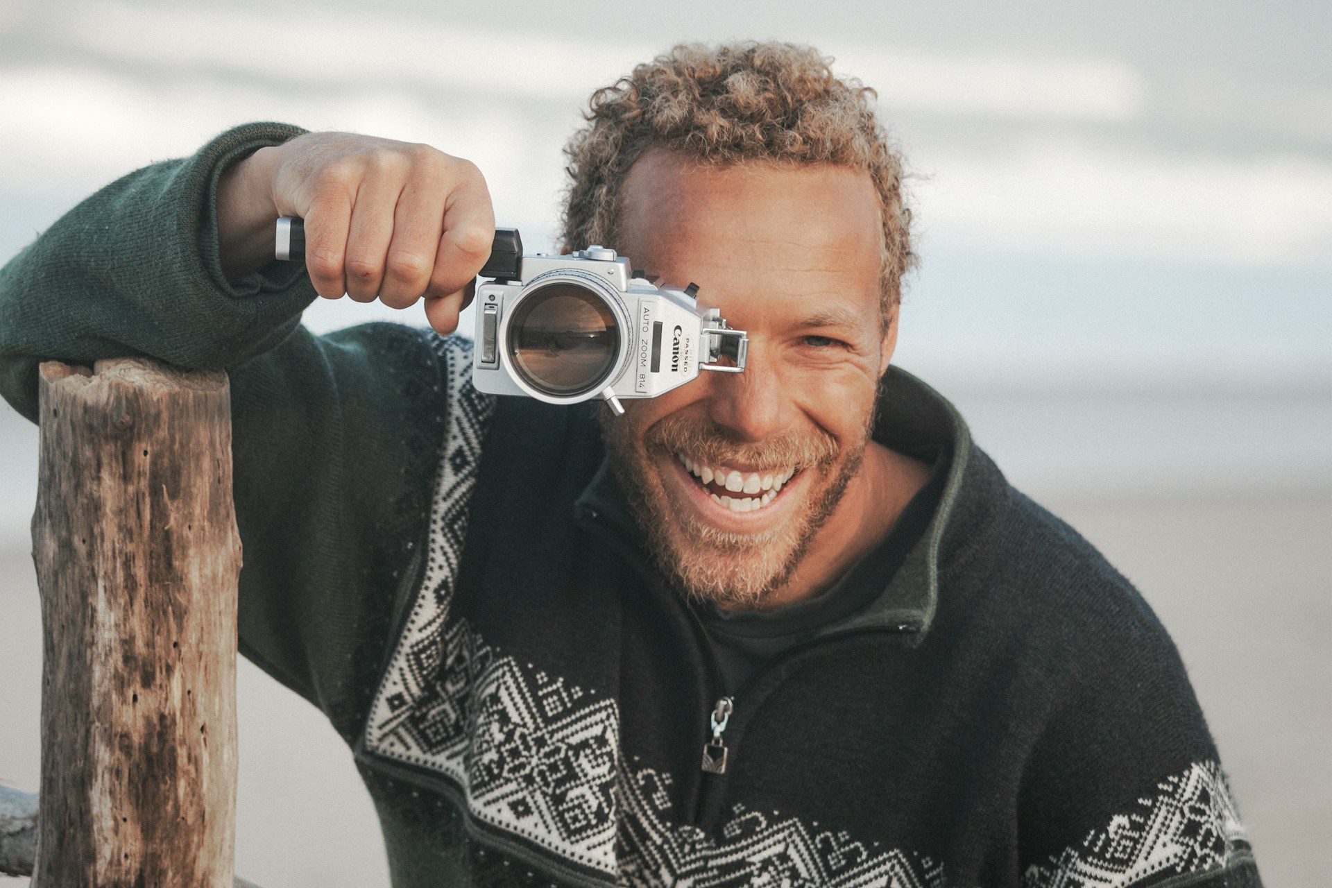 A man looks into a camera, as if looking for the answer to the question: What does a book editor do?